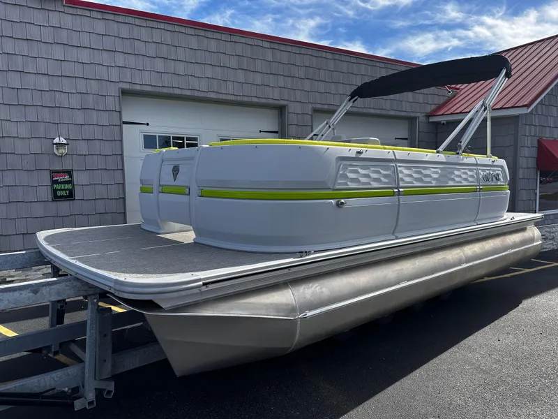 Slide: The Image of 2025 Avalon 2185 Aura Quad Lounge pontoon boat with canopy, docked outdoors. - 2