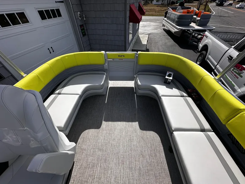Slide: The Image of 2025 Avalon 2185 Aura Quad Lounge interior with yellow seating, parked near garage. - 20