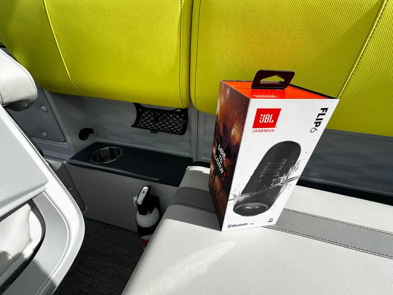 Slide: The Image of JBL Flip 6 speaker box on Avalon 2185 Aura Quad Lounge boat seat, 2025 model. - 25