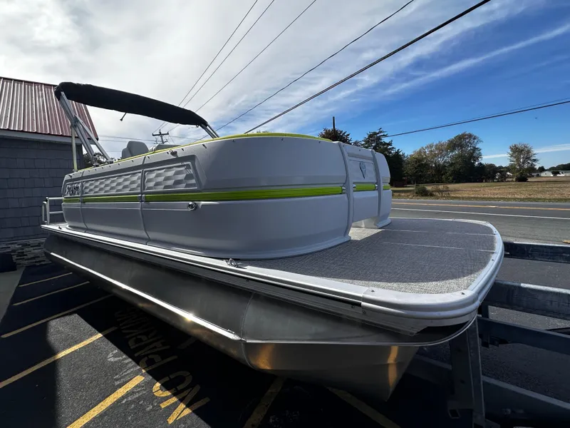 Slide: The Image of 2025 Avalon 2185 Aura Quad Lounge pontoon boat, parked outdoors under a clear sky. - 8