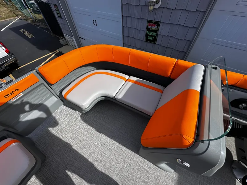Slide: The Image of 2025 Avalon 2385 Aura Quad Lounge boat with orange and gray seating. - 12