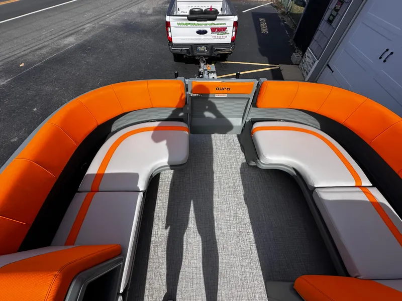 Slide: The Image of 2025 Avalon 2385 Aura Quad Lounge interior with orange and gray seating, viewed from above. - 13