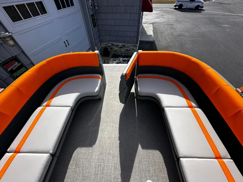 Slide: The Image of 2025 Avalon 2385 Aura Quad Lounge interior with orange and gray seating. - 20