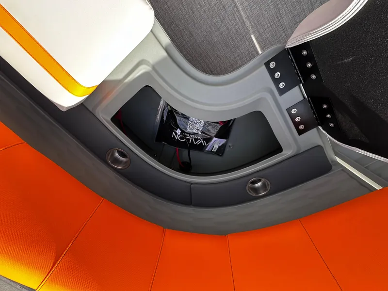 Slide: The Image of 2025 Avalon 2385 Aura Quad Lounge interior with orange seating and storage compartment. - 21