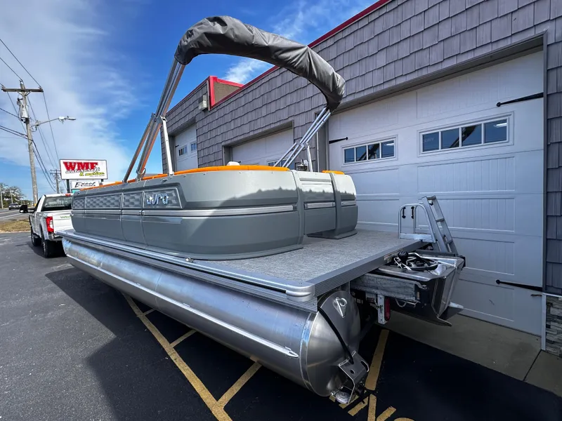 Slide: The Image of 2025 Avalon 2385 Aura Quad Lounge pontoon boat parked outside a garage. - 4