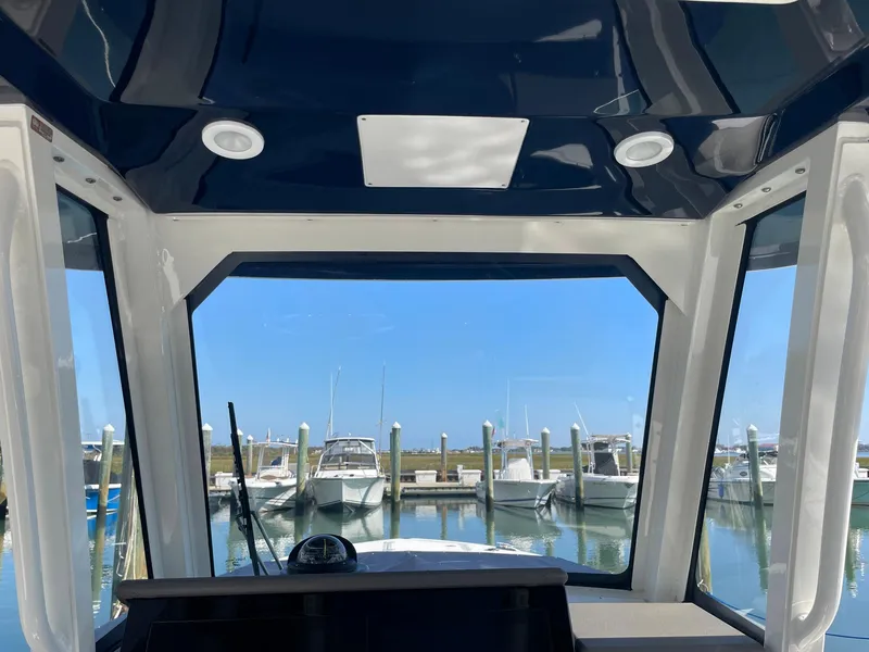 Slide: The Image of Interior view of 2020 Pursuit S 288 boat overlooking marina with docked boats. - 17