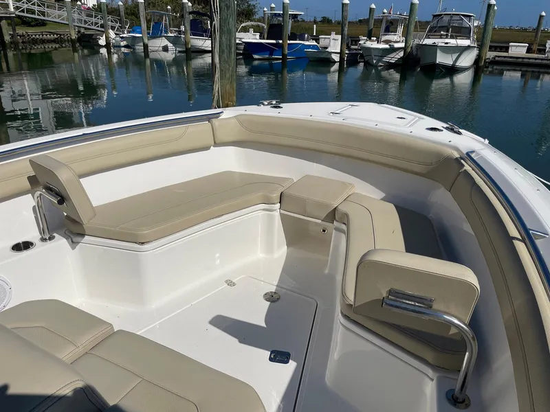 Slide: The Image of 2020 Pursuit S 288 boat with beige seating in a marina. - 3