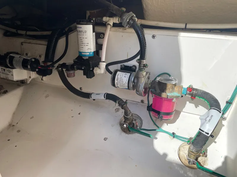 Slide: The Image of 2020 Pursuit S 288 boat plumbing system with hoses and filters. - 38