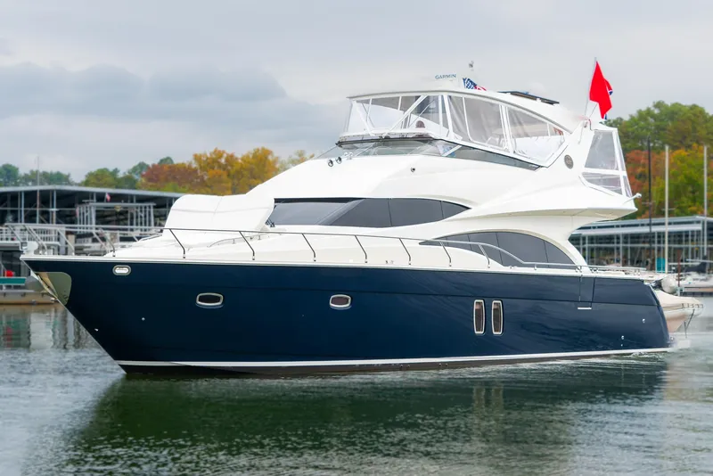 Slide: The Image of 2007 Marquis 59 Markham Edition yacht on calm water, featuring sleek design and luxury amenities. - 10