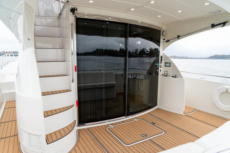Slide: The Image of Luxury yacht deck with stairs, glass doors, and wood flooring; 2007 Marquis 59 Markham Edition. - 14