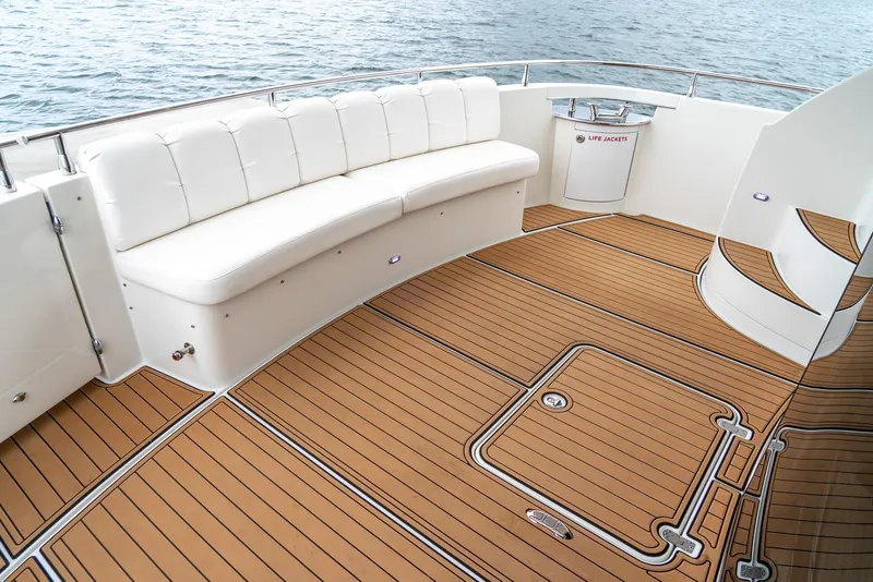 Slide: The Image of Luxurious 2007 Marquis 59 Markham Edition yacht deck with white seating and teak flooring. - 16