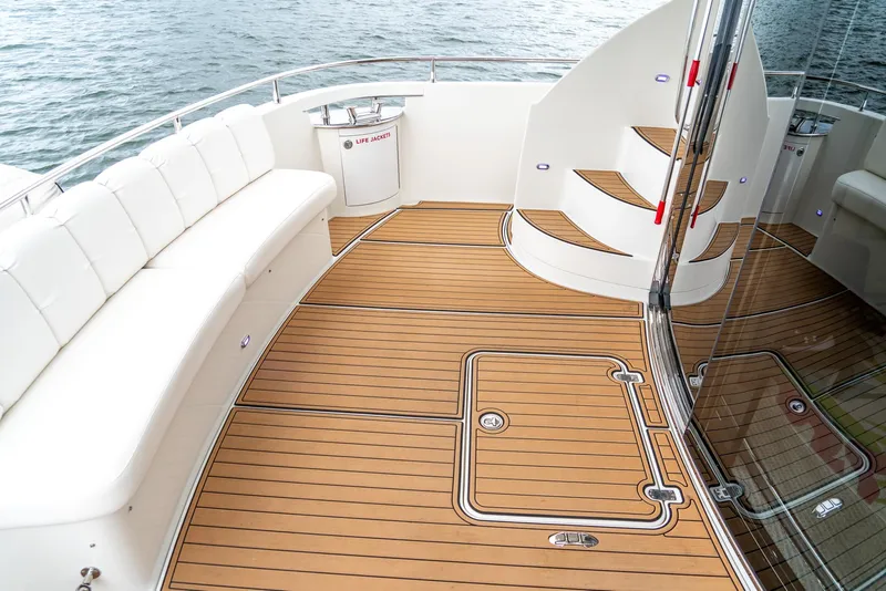 Slide: The Image of Luxurious 2007 Marquis 59 Markham Edition yacht deck with elegant seating and wood flooring. - 17