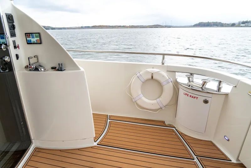 Slide: The Image of Luxurious 2007 Marquis 59 Markham Edition yacht deck with life ring and wood flooring. - 19