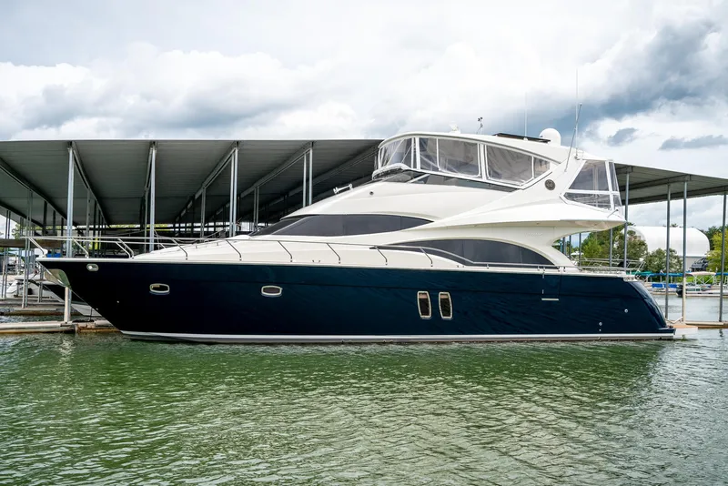 Slide: The Image of 2007 Marquis 59 Markham Edition yacht docked under a covered marina. - 2