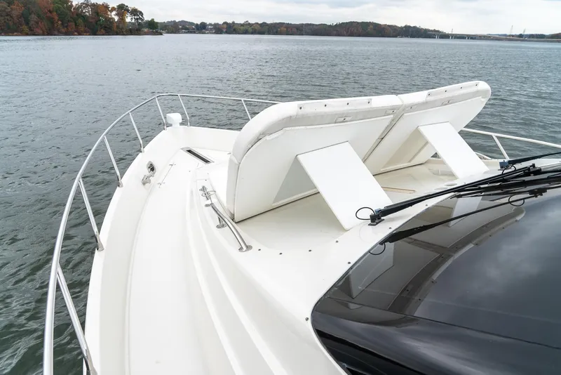 Slide: The Image of 2007 Marquis 59 Markham Edition yacht on calm water, featuring sleek white deck design. - 26