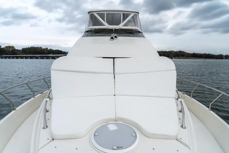 Slide: The Image of 2007 Marquis 59 Markham Edition yacht bow with white seating, on a cloudy day. - 28