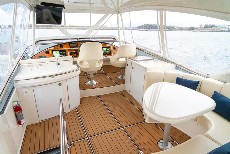 Slide: The Image of Luxurious 2007 Marquis 59 Markham Edition yacht interior with elegant seating and navigation area. - 32