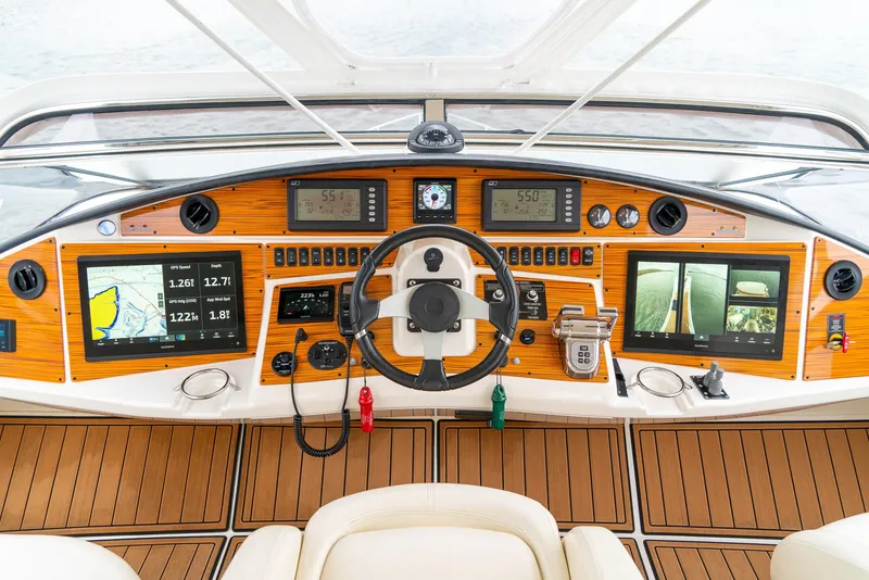 Slide: The Image of 2007 Marquis 59 Markham Edition yacht dashboard with advanced navigation systems and controls. - 36