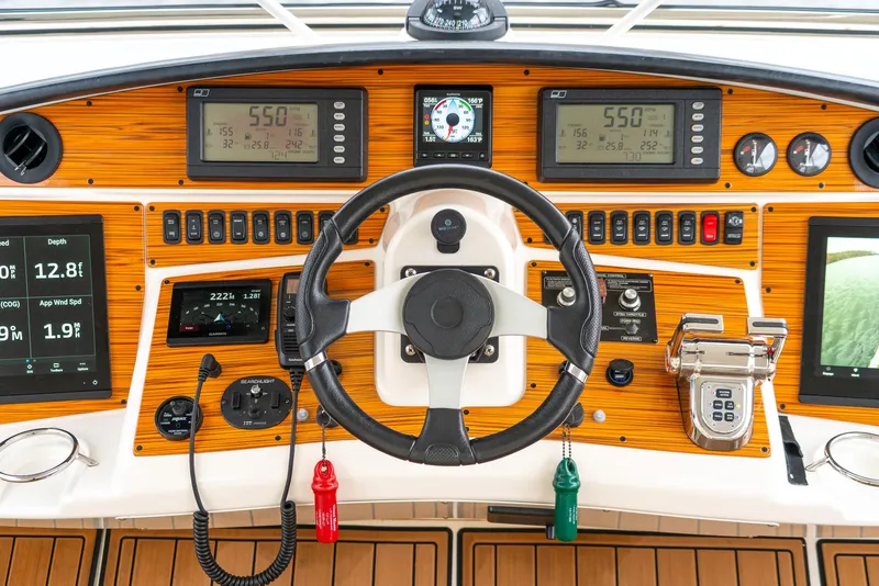 Slide: The Image of Dashboard of 2007 Marquis 59 Markham Edition yacht with steering wheel and navigation controls. - 38