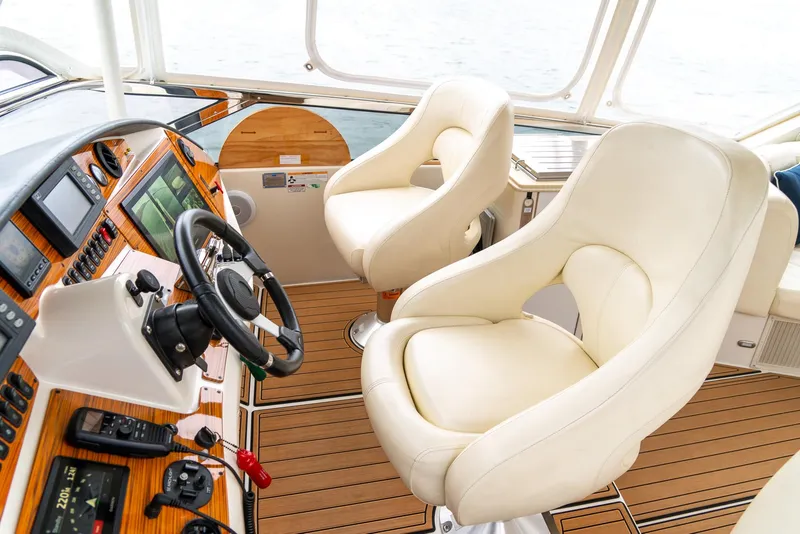 Slide: The Image of Luxurious 2007 Marquis 59 Markham Edition yacht cockpit with plush seating and advanced controls. - 42