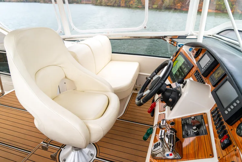 Slide: The Image of Luxurious 2007 Marquis 59 Markham Edition yacht cockpit with leather seating and advanced navigation controls. - 43