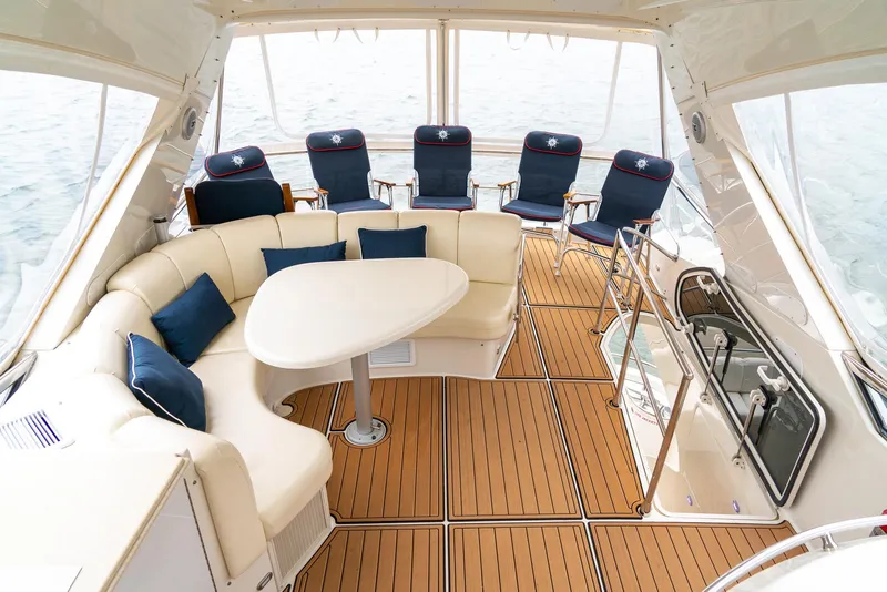 Slide: The Image of Luxurious 2007 Marquis 59 Markham Edition yacht interior with elegant seating and wooden flooring. - 46