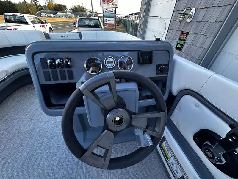Slide: The Image of Steering console of 2025 Avalon 2385 Aura Quad Lounge boat with modern controls. - 10