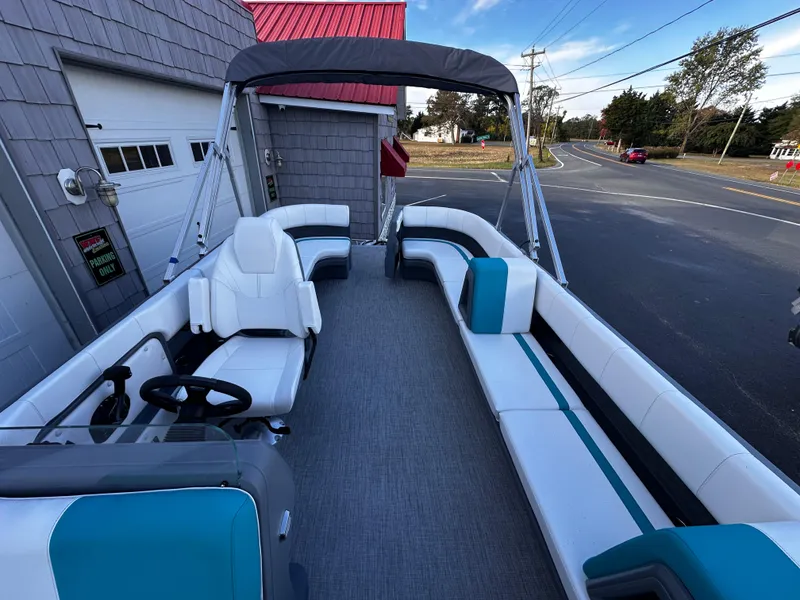 Slide: The Image of 2025 Avalon 2385 Aura Quad Lounge pontoon boat with spacious seating and modern design. - 12