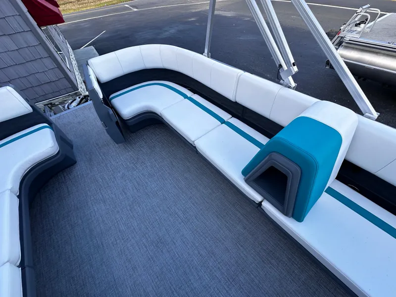 Slide: The Image of 2025 Avalon 2385 Aura Quad Lounge interior with white and teal seating. - 14