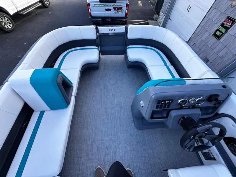 Slide: The Image of 2025 Avalon 2385 Aura Quad Lounge interior with modern seating and steering console. - 16