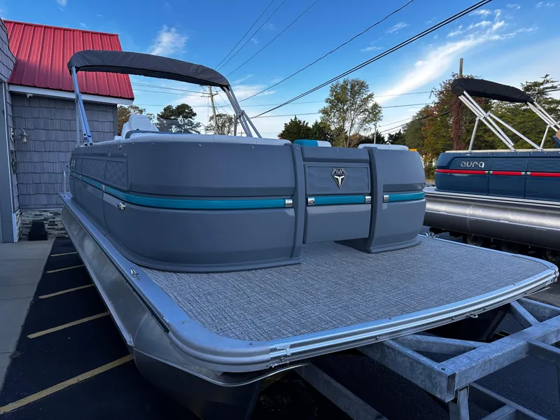 Slide: The Image of 2025 Avalon 2385 Aura Quad Lounge pontoon boat on display outdoors. - 5