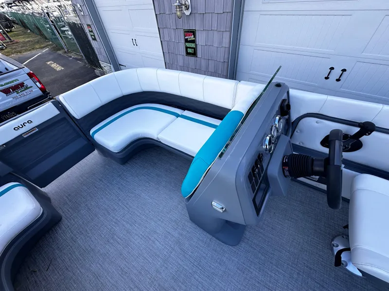 Slide: The Image of 2025 Avalon 2385 Aura Quad Lounge interior with modern seating and steering console. - 8