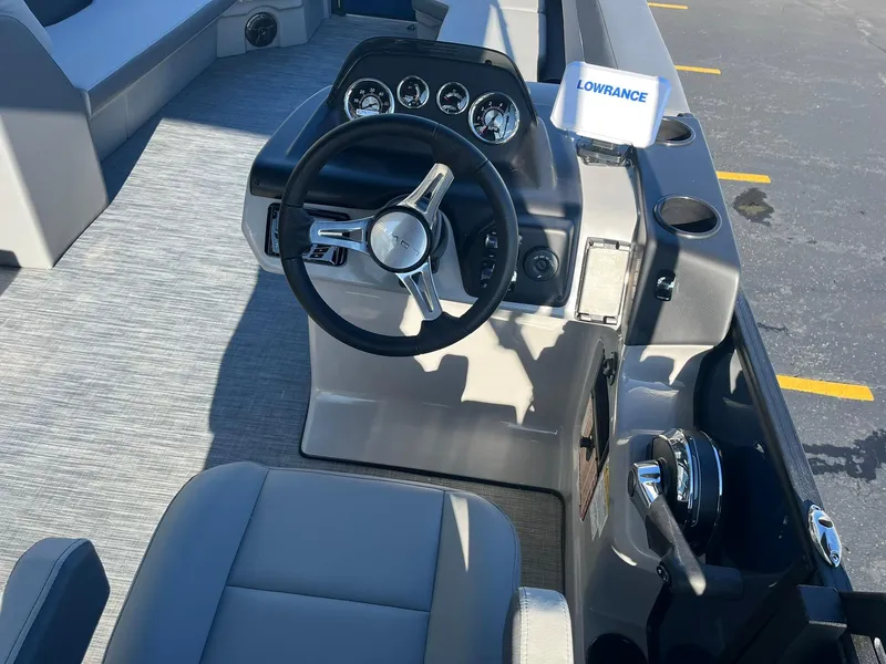 Slide: The Image of 2025 Lowe LS 230 WT boat cockpit with steering wheel and control panel. - 10