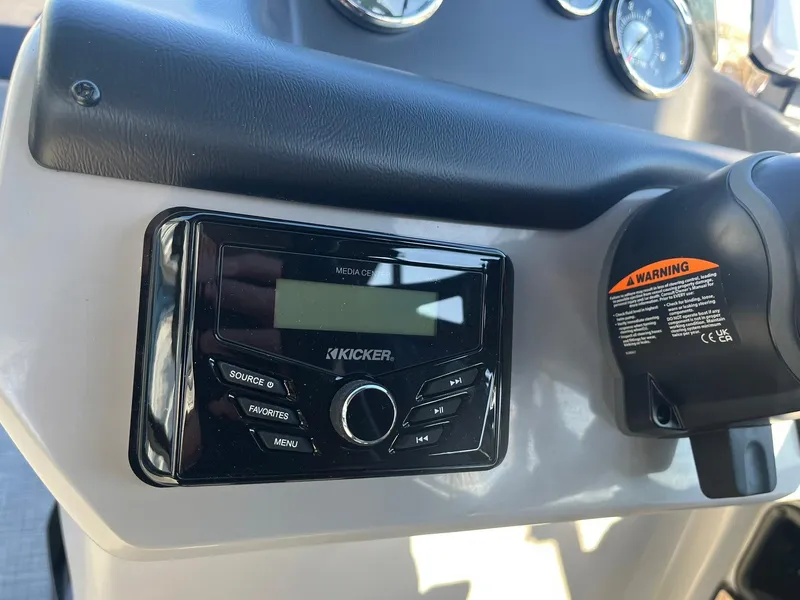 Slide: The Image of Kicker audio system on 2025 Lowe LS 230 WT boat dashboard. - 13