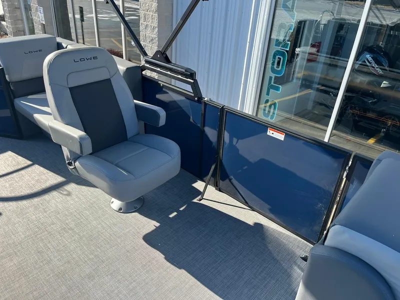 Slide: The Image of 2025 Lowe LS 230 WT boat interior with gray seating and blue paneling. - 15