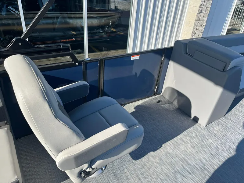 Slide: The Image of 2025 Lowe LS 230 WT boat interior with gray seating and carpeted floor. - 16