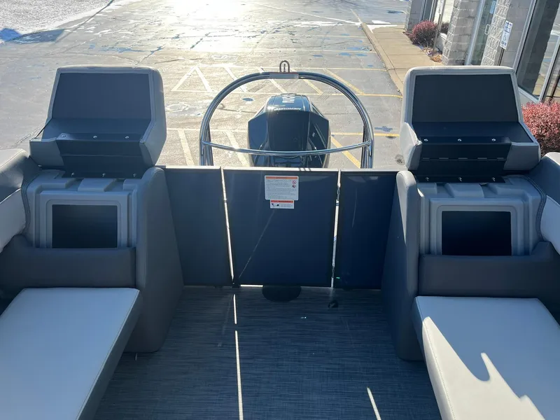 Slide: The Image of 2025 Lowe LS 230 WT boat interior with seating and steering wheel. - 18