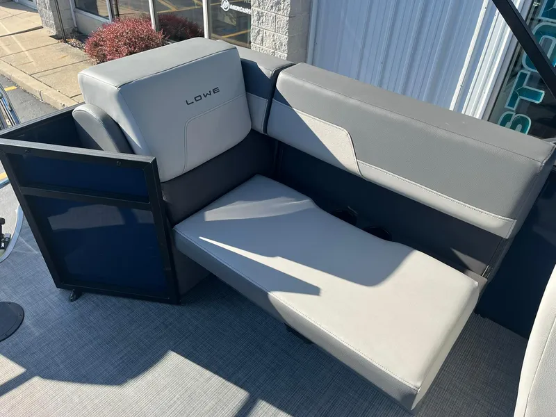 Slide: The Image of 2025 Lowe LS 230 WT boat interior with gray seating and adjustable lounge chair. - 20