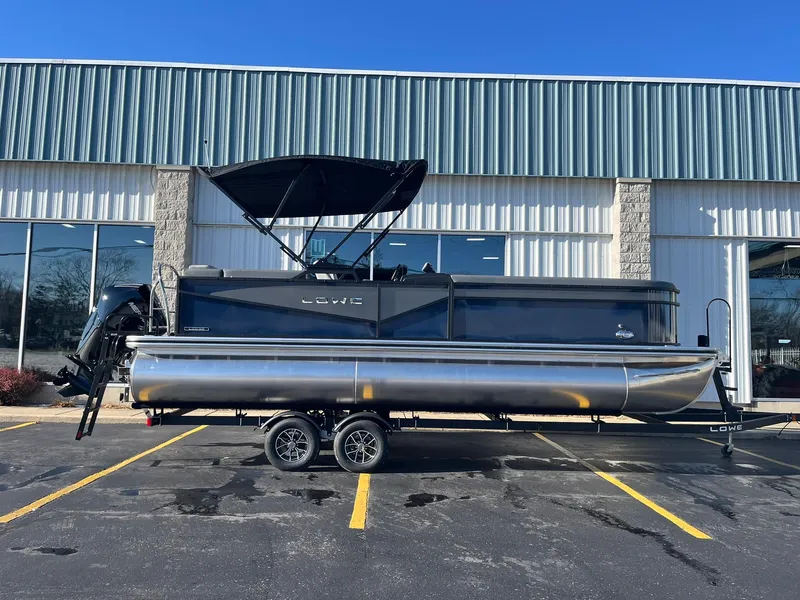 Slide: The Image of 2025 Lowe LS 230 WT pontoon boat parked outside a building. - 29