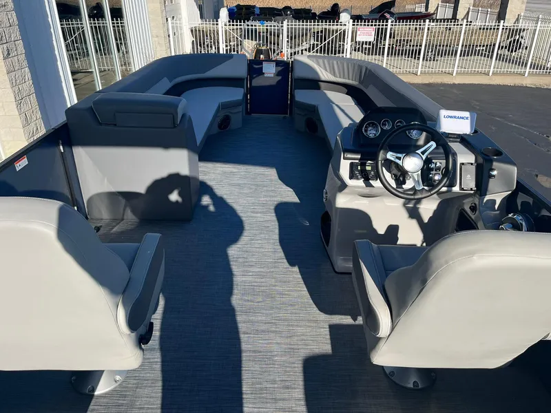 Slide: The Image of 2025 Lowe LS 230 WT boat interior with gray seating and modern steering console. - 6