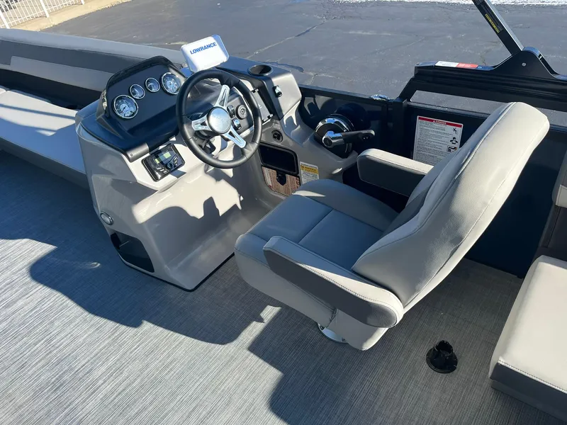 Slide: The Image of 2025 Lowe LS 230 WT boat interior with steering console and comfortable seating. - 8