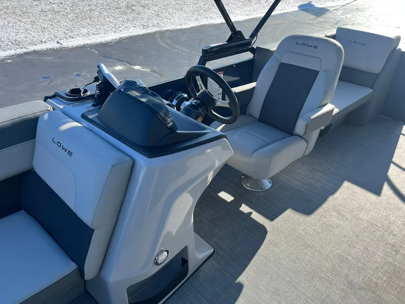 Slide: The Image of 2025 Lowe LS 230 WT boat interior with modern seating and steering console. - 9