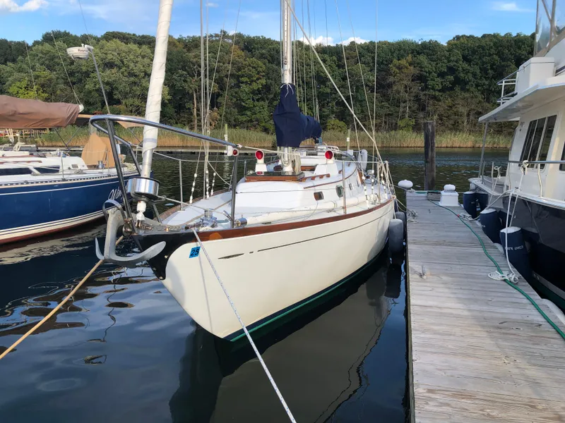 Slide: The Image of Vintage 1968 LeComte Northeast 38 sailboat docked in a serene marina setting. - 10