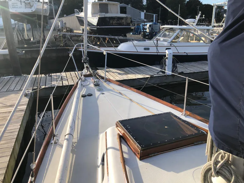 Slide: The Image of 1968 LeComte Northeast 38 sailboat docked at marina, showcasing deck and rigging. - 11