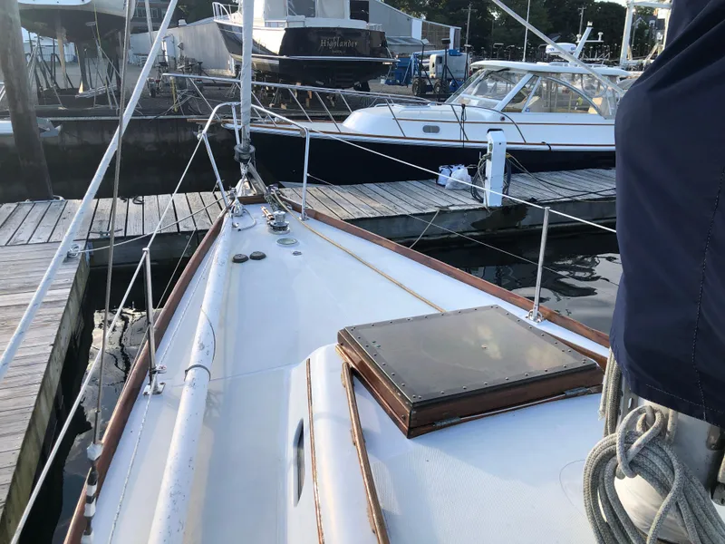 Slide: The Image of 1968 LeComte Northeast 38 sailboat docked at marina, showcasing deck and rigging. - 13