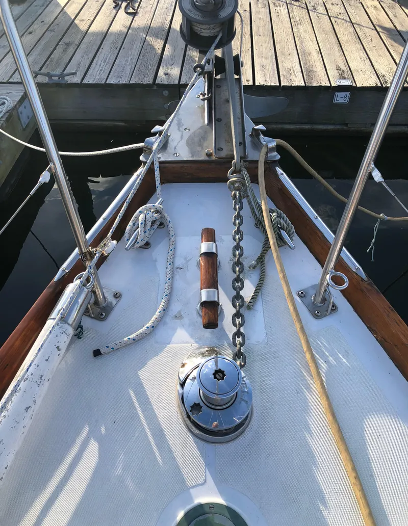 Slide: The Image of 1968 LeComte Northeast 38 sailboat deck with anchor chain and wooden handrail. - 16
