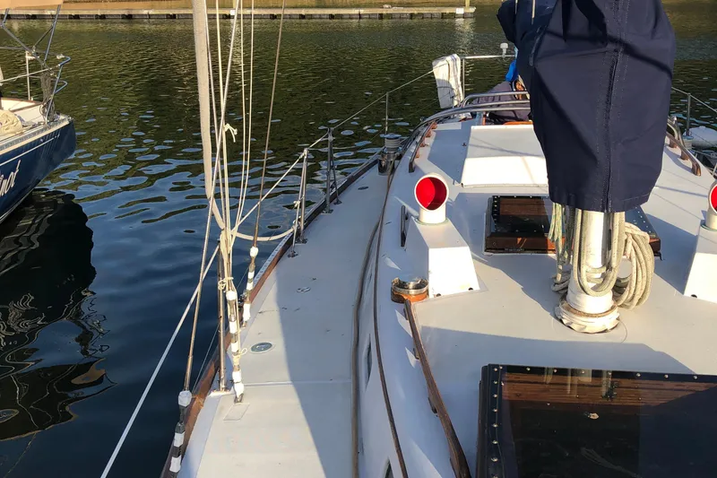 Slide: The Image of 1968 LeComte Northeast 38 sailboat docked, showing deck and rigging details. - 19