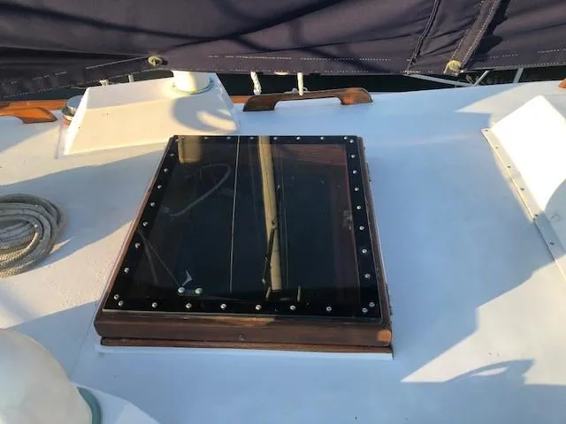 Slide: The Image of 1968 LeComte Northeast 38 yacht deck with a glass hatch and rope. - 21