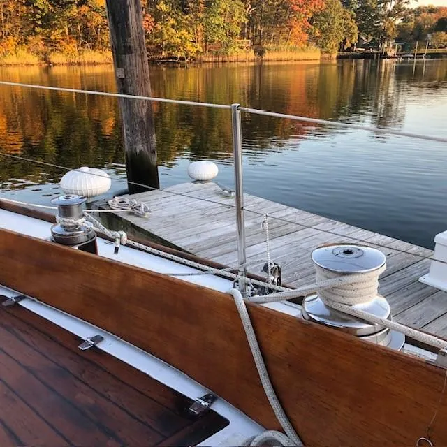 Slide: The Image of 1968 LeComte Northeast 38 sailboat docked by a serene autumn lake. - 23