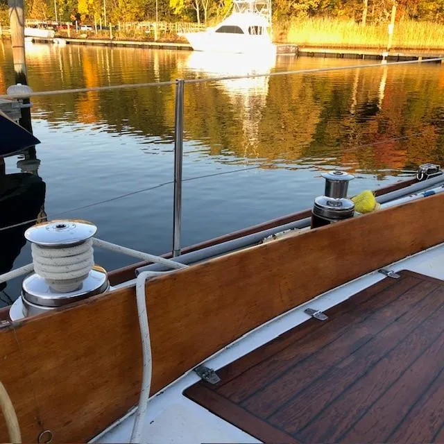 Slide: The Image of 1968 LeComte Northeast 38 sailboat deck with autumn reflections on calm water. - 24